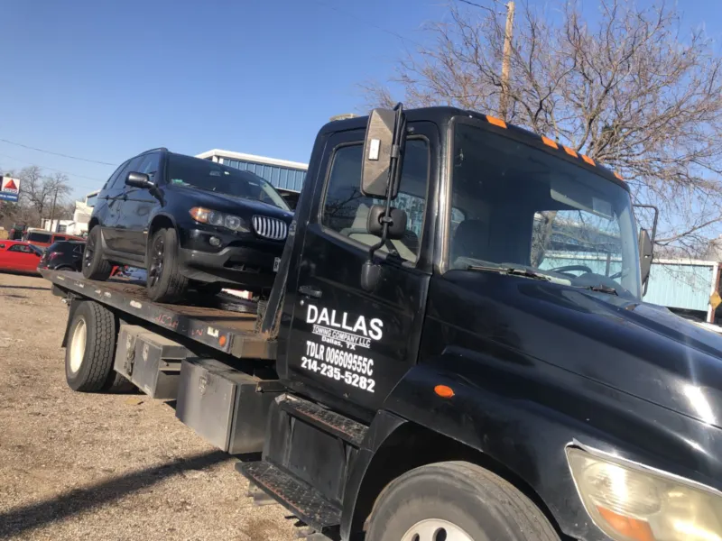 BMW X5 on a Dallas Towing Company flatbed in Dallas, TX
