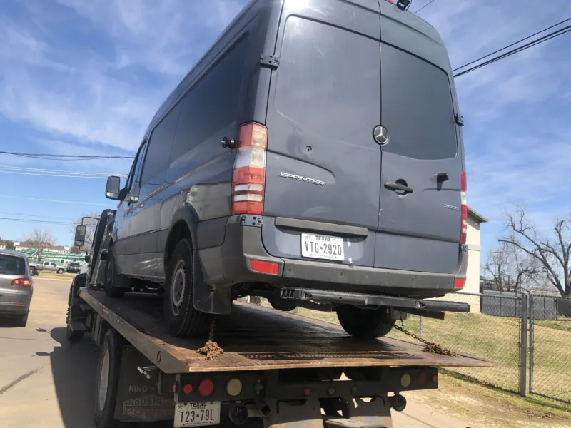 Mercedes Sprinter van on a Dallas Towing Company flatbed
