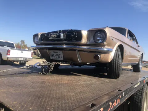 Classic Ford Mustang on a Dallas Towing Company flatbed