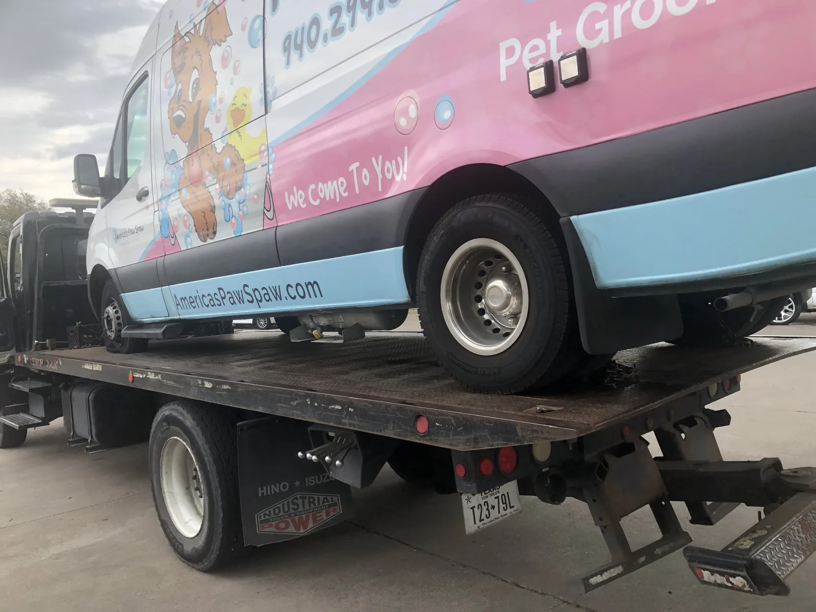 Commercial van loaded on a Dallas Towing Company flatbed