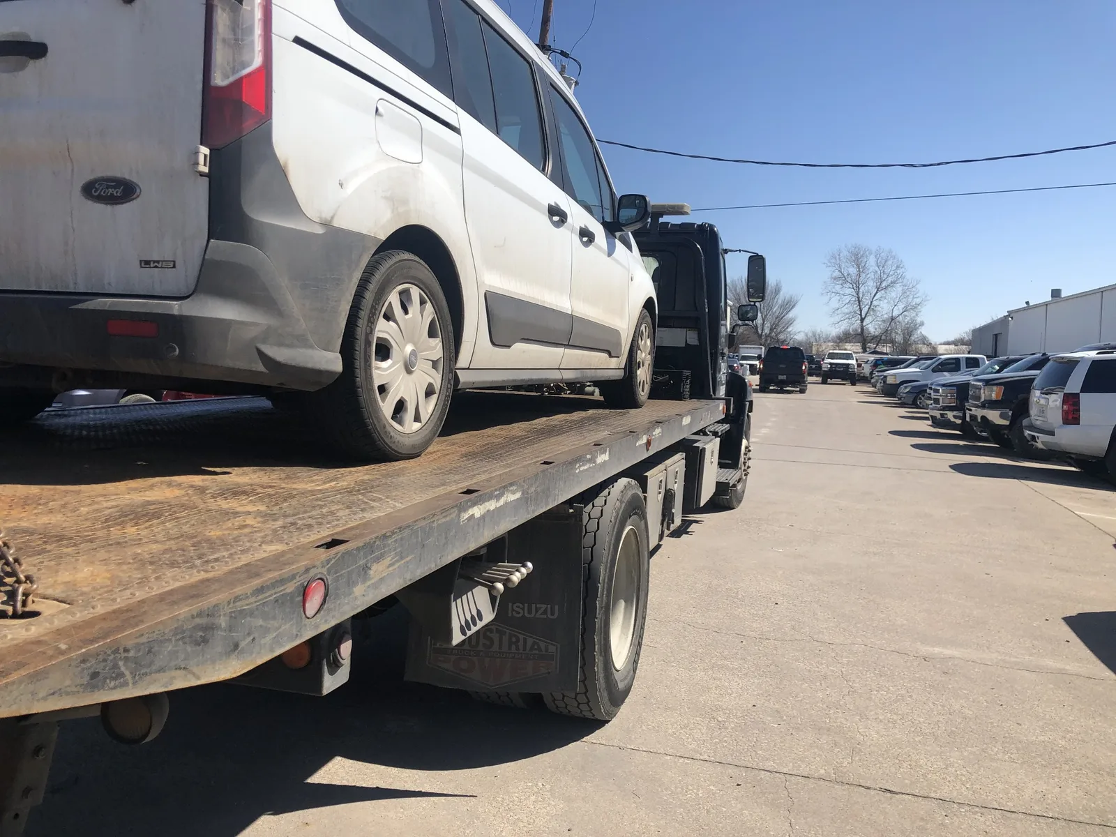 Ford Transit Connect van on a Dallas Towing Company flatbed