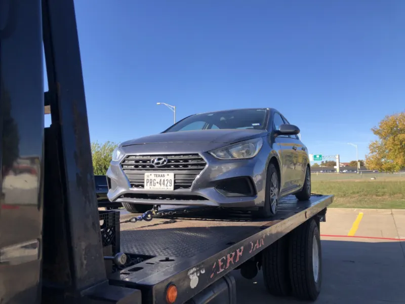 Hyundai sedan secured on a Dallas Towing Company flatbed